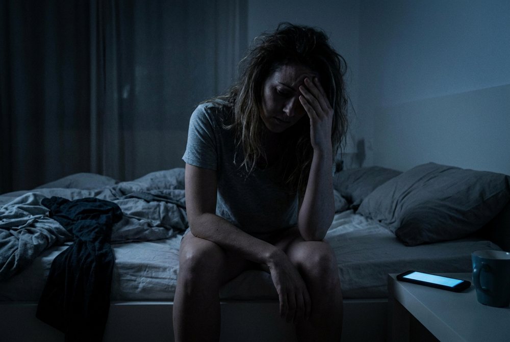 Woman awake at night, unable to sleep